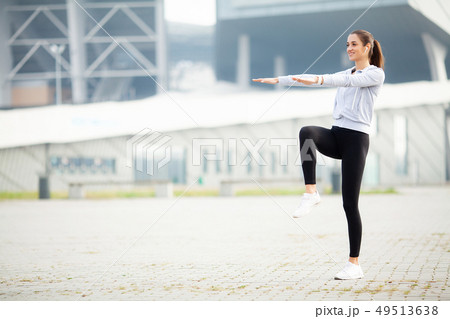 Sport outdoor. Woman Listening Music On Phone While Exercising Outdoors 49513638
