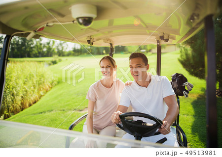 Golf Player Teeing the Ball Squatting on a Turf. Golf Player Teeing the Ball Squatting on a Turf. 49513981