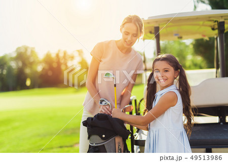 Golf Player Teeing the Ball Squatting on a Turf. 49513986