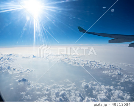 Clouds and sky as seen through window of an aircra Clouds and sky as seen through window of an aircra 49515084