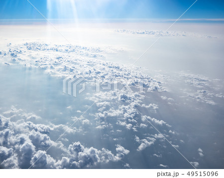 Clouds and sky as seen through window of an aircra Clouds and sky as seen through window of an aircra 49515096