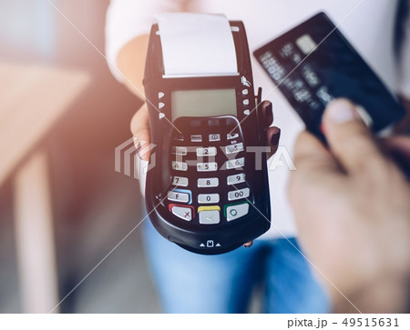 Man paying with contactless credit card for coffee Man paying with contactless credit card for coffee 49515631