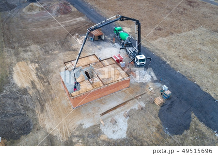 Pouring concrete from a concrete mixer 49515696