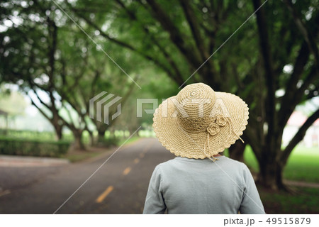 woman take a walk on the way under the trees woman take a walk on the way under the trees 49515879