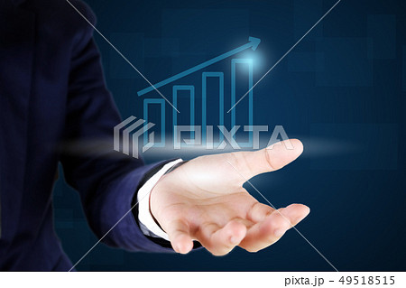 Businessman holding a growth graph. 49518515