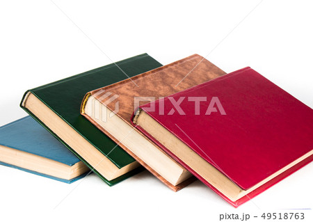 Multi-colored books lie chaotically in isolated on white background Multi-colored books lie chaotically in isolated on white background 49518763