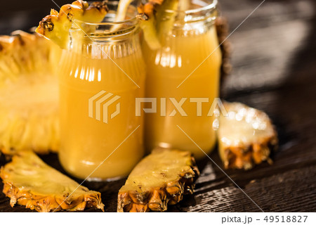 Pineapple juice and slice placed on a wooden table Pineapple juice and slice placed on a wooden table 49518827