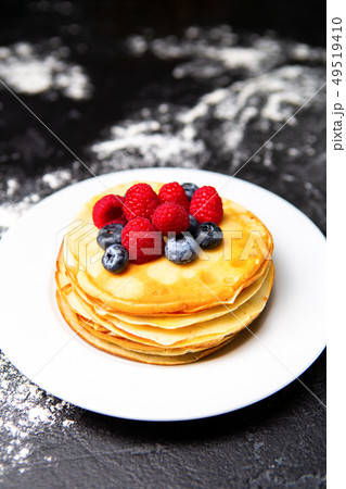 Photo from top of plate with pancakes, blueberries, raspberries 49519410