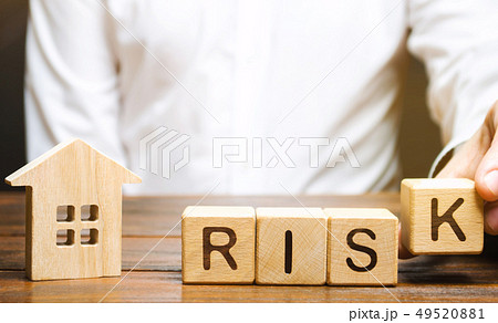 Businessman puts wooden blocks with the word Risk 49520881