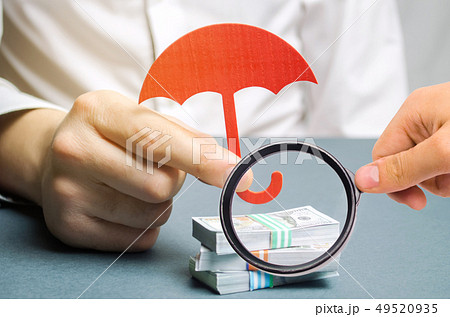 An insurance agent holds a red umbrella  49520935