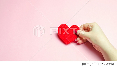 The girl holds a red heart in hands. Valentine's 49520948