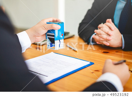 House real estate sell agent reviews the documents 49523192