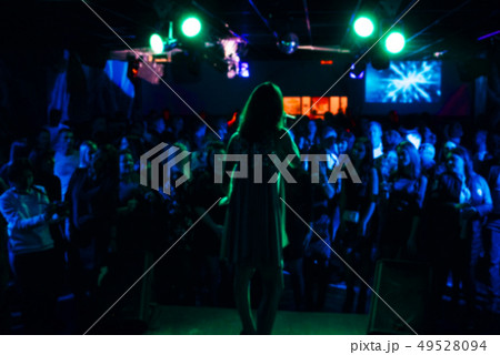 blurred silhouette of the singer on stage and crowds 49528094