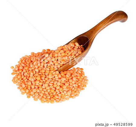 Lentils in the wooden spoon, isolated on white background. 49528599