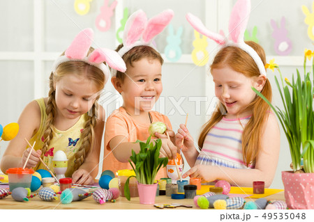 cute kids painting Easter eggs at home. cute kids painting Easter eggs at home. 49535048