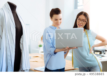 Delighted brunette looking at computer Delighted brunette looking at computer 49538665