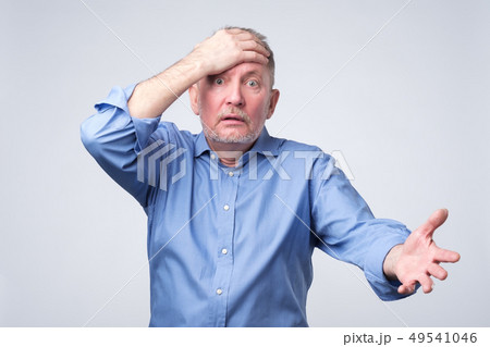 Senior caucasian man surprised with hand on head. Senior caucasian man surprised with hand on head. 49541046