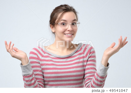 Woman shrugging hands and expressing confusion  49541047
