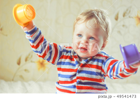 The child plays on the bed The child plays on the bed 49541473