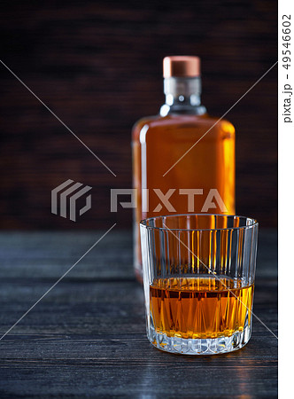 Whiskey on a black wooden tableSilhouette of a Whiskey on a black wooden tableSilhouette of a 49546602