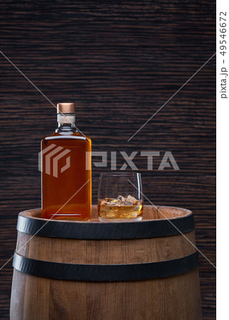 whiskey with ice cube on a wooden table whiskey with ice cube on a wooden table 49546672