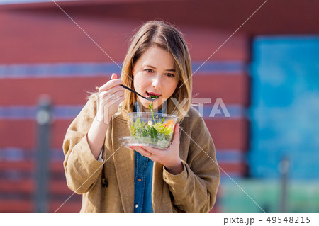 Young businesswoman with salad at urban city outdoor. Young businesswoman with salad at urban city outdoor. 49548215
