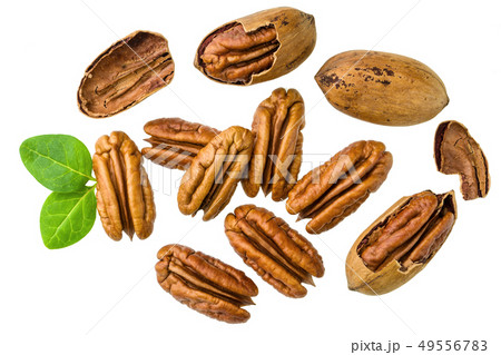 Pecans piles  with green leaves,top view 49556783