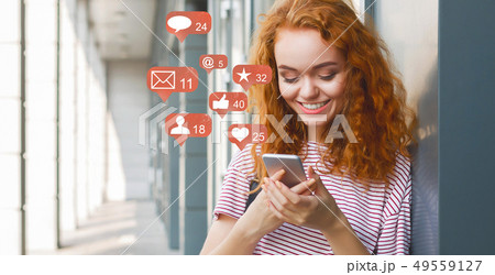 Blogger using phone with social media notification icons Blogger using phone with social media notification icons 49559127