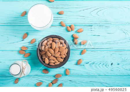 Almond milk on wooden table 49560025