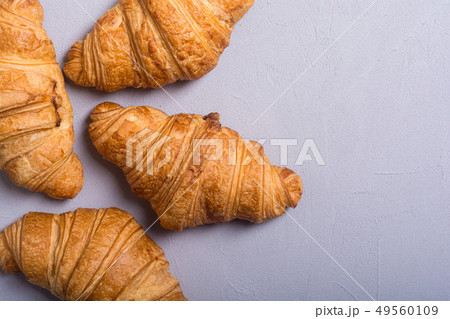 Croissants on wooden background Croissants on wooden background 49560109