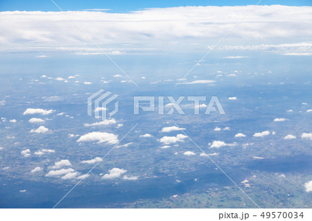 Clouds, sky and ground, looking from the plane. 49570034