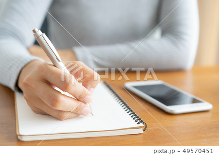 Asian women take notes with a pen in the office Asian women take notes with a pen in the office 49570451
