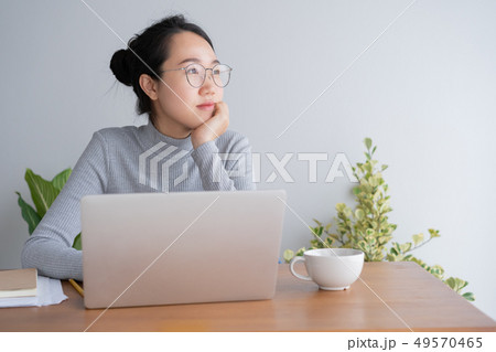 Young asian woman working on laptop in the home Young asian woman working on laptop in the home 49570465