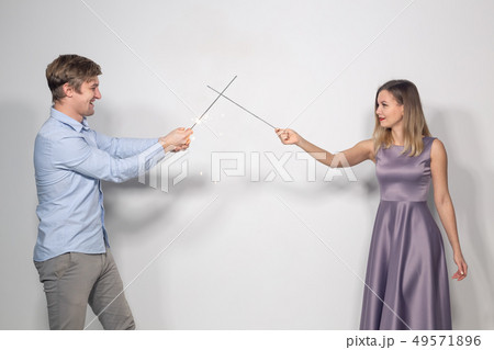 Holidays, party and celebrations concept - young couple with sparklers on white background Holidays, party and celebrations concept - young couple with sparklers on white background 49571896