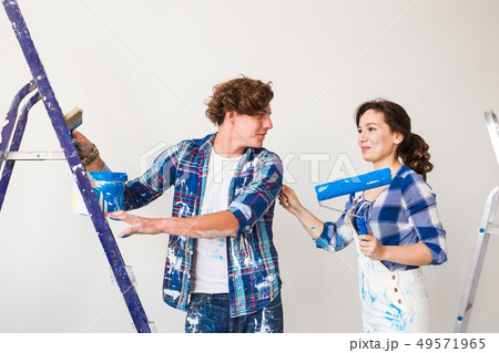 People, renovation and repair concept - Portrait of lovely couple doing redecoration in apartment 49571965