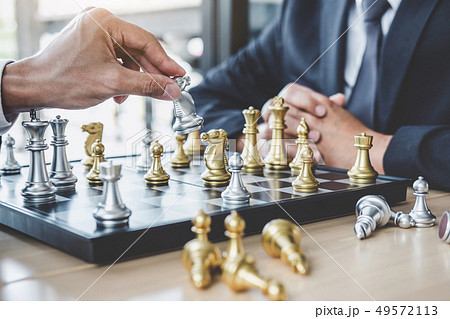 Two businessman playing chess game to plan Two businessman playing chess game to plan 49572113