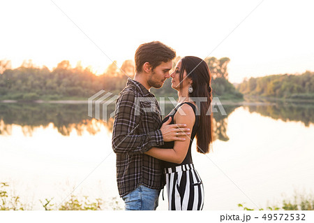 Relationship, love and nature concept - Close up portrait of attractive woman and handsome man 49572532