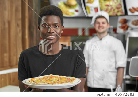 Selective focus of satisfied client keeping delicious pizza 49572683