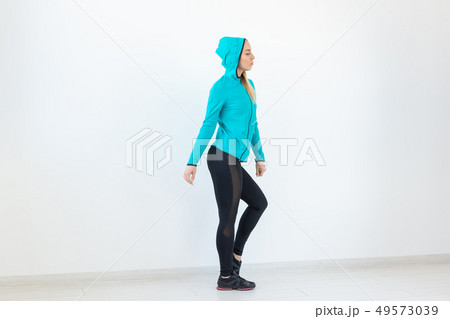 People, sport and fitness concept - attractive young woman in sportswear posing on white background People, sport and fitness concept - attractive young woman in sportswear posing on white background 49573039