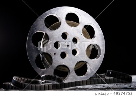 35 mm film reel with dramatic lighting on a dark 35 mm film reel with dramatic lighting on a dark 49574752