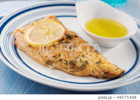Fried fish with lemon and spices Fried fish with lemon and spices 49575408
