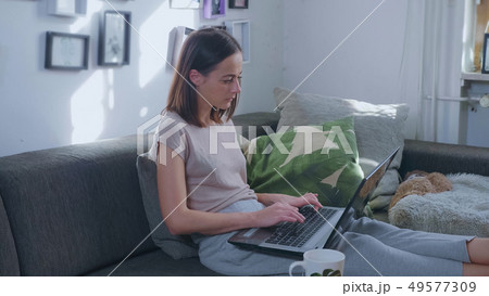 Young woman works in her home office with her laptop 49577309