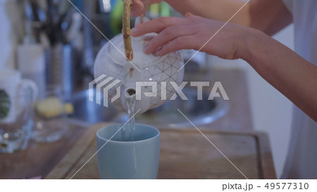 Preparing a cup of hot tea in the kitchen 49577310