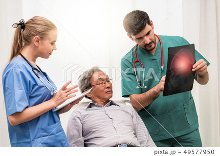 Doctor team work with x ray film image of patient. Doctor team work with x ray film image of patient. 49577950