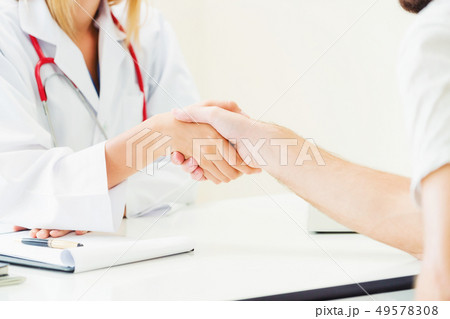 Doctor shake hand with patient in the hospital. Doctor shake hand with patient in the hospital. 49578308