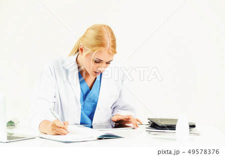 Doctor in hospital working on medical report. 49578376