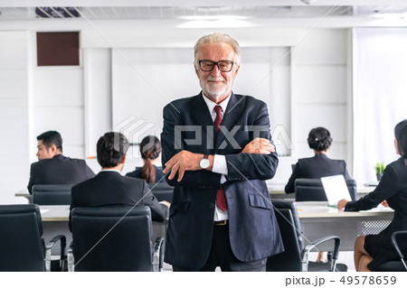 Senior executive CEO manager with team members. Senior executive CEO manager with team members. 49578659