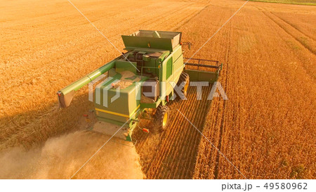 Combine harvester on golden field. Combine harvester on golden field. 49580962
