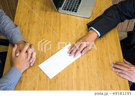 Hand of a businessman hands over a resignation Hand of a businessman hands over a resignation 49581295
