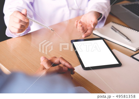 Doctor with a thermometer in his hand taking 49581358